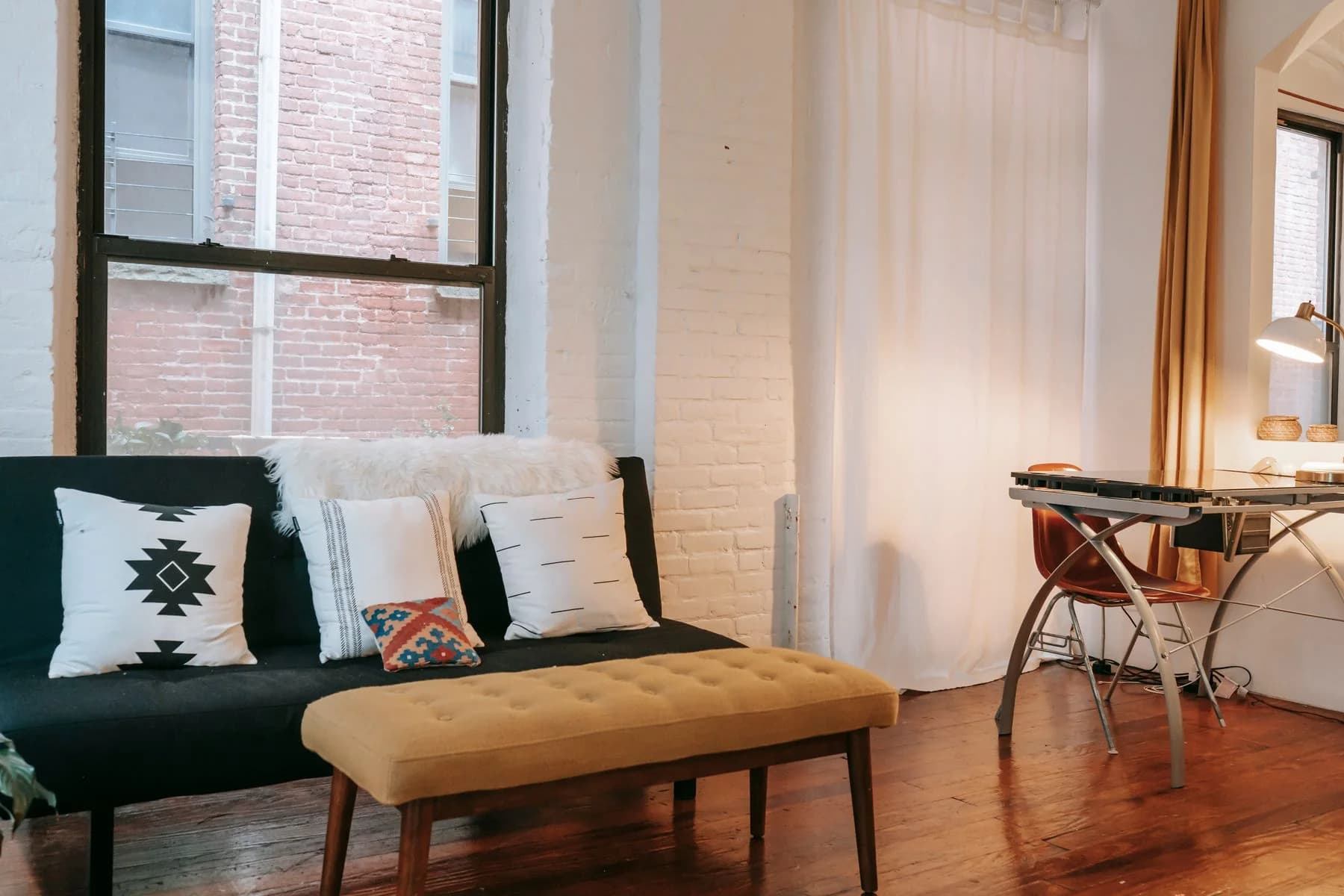 A sunlit living room with comfortable seating