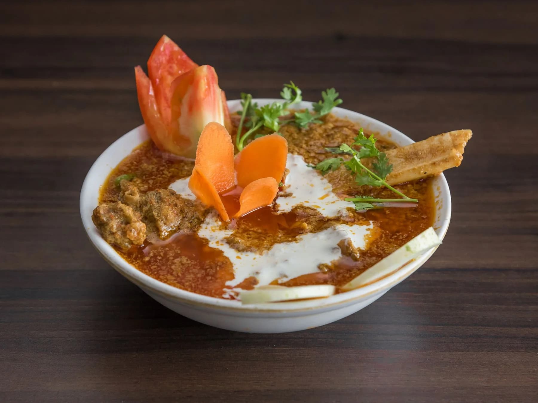 Indian curry garnished with fresh herbs