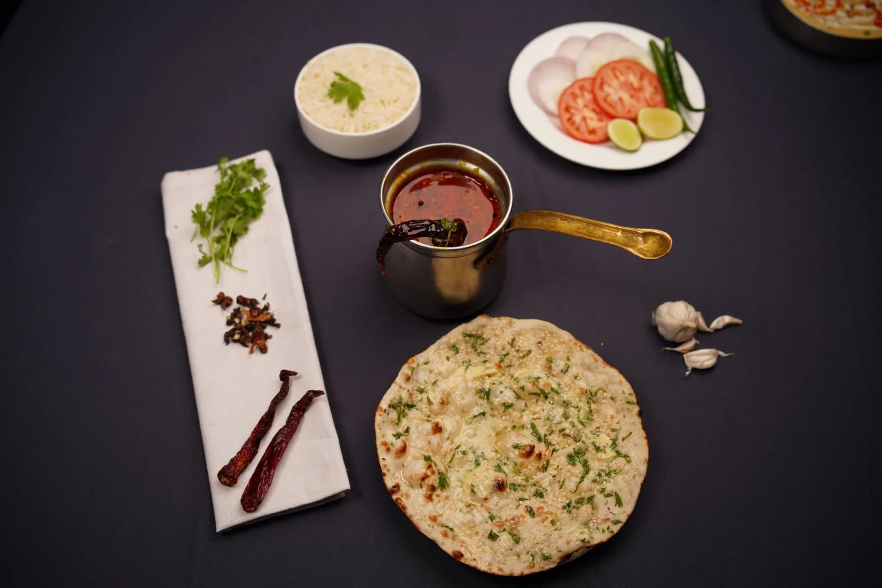 Naan bread and Indian dishes on a table