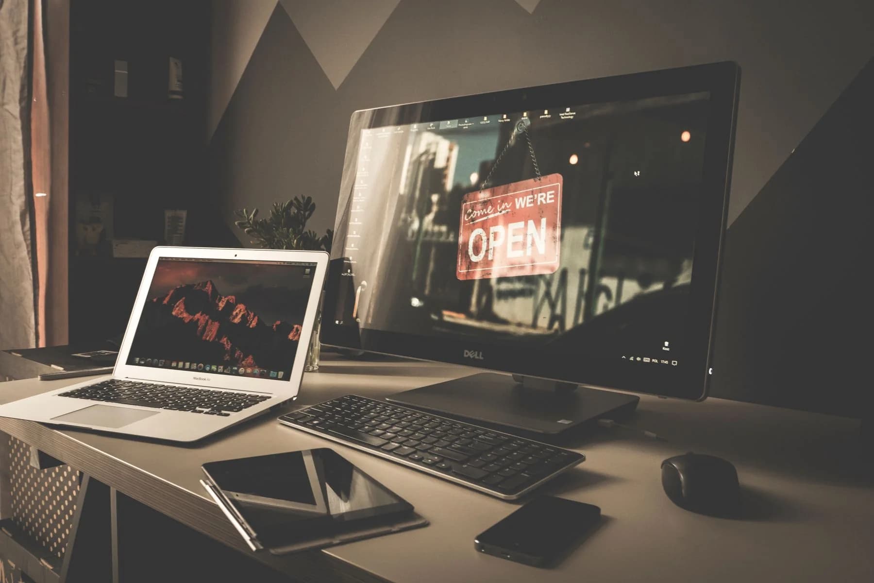 An organized workspace with a computer and laptop